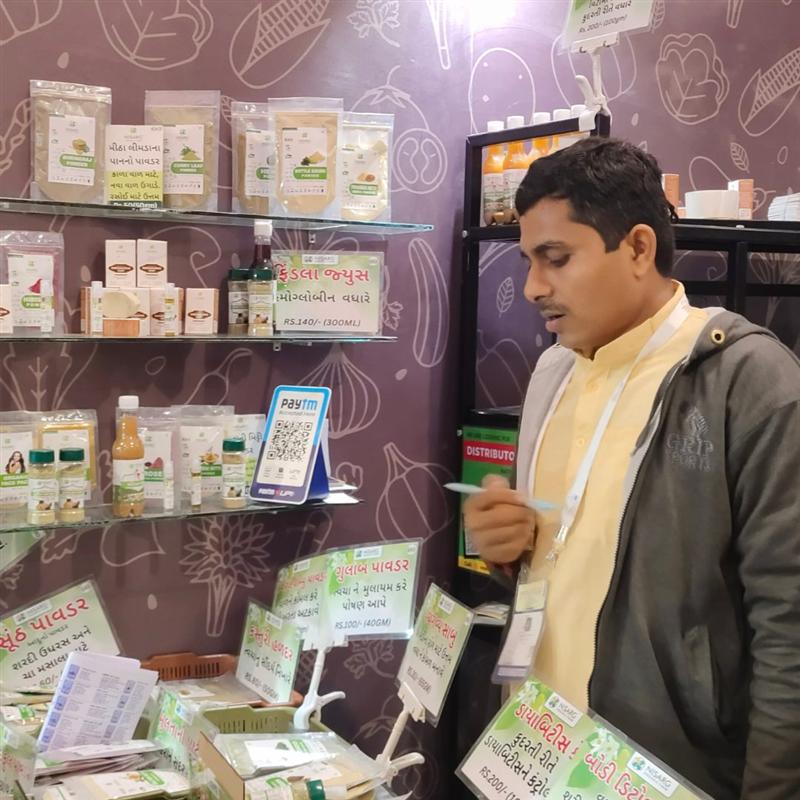Nisarg Organic Farm founder presenting products at an organic exhibition stall