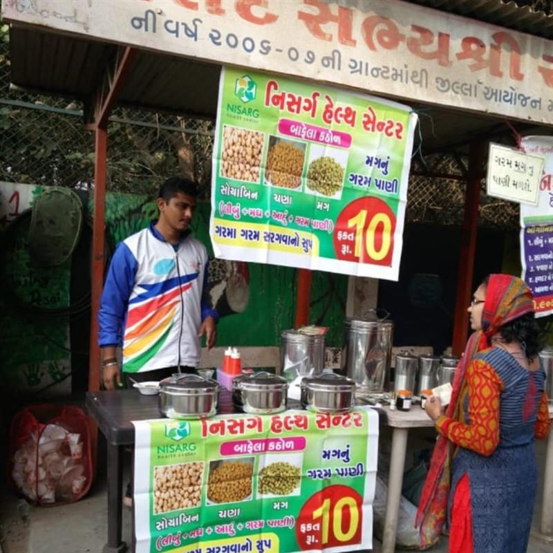 Nisarg Organic Farm stall at an organic products exhibition displaying herbal powders